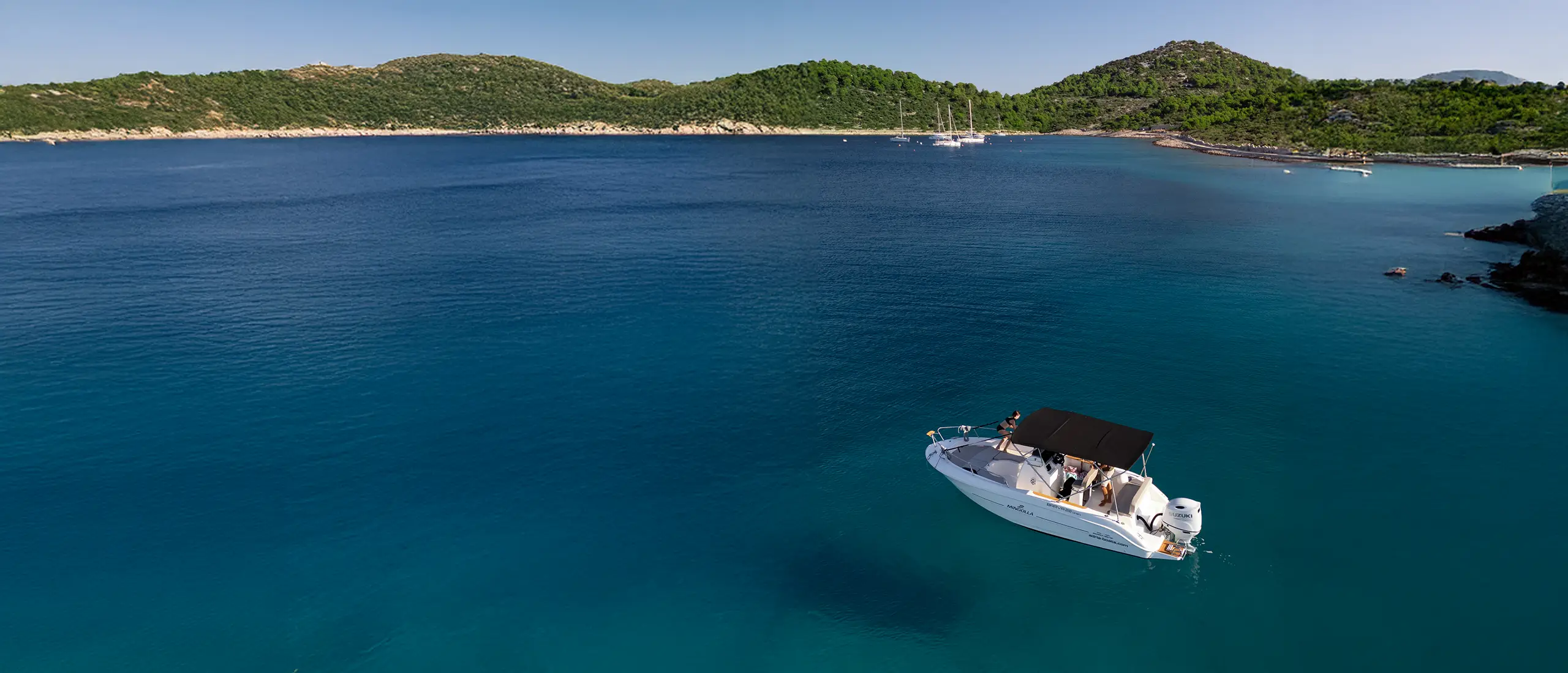 Private boat charter Šibenik, aerial view of islands and motorboat Adriatic Croatia